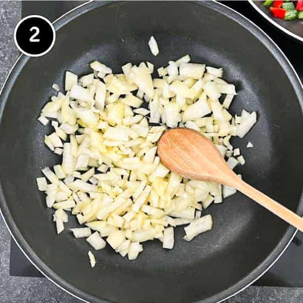 Diced onions frying in a pan