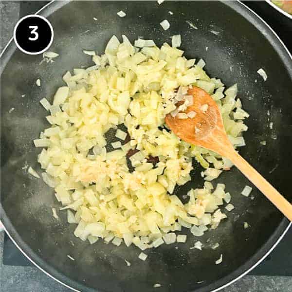 Adding garlic to sautéed onions