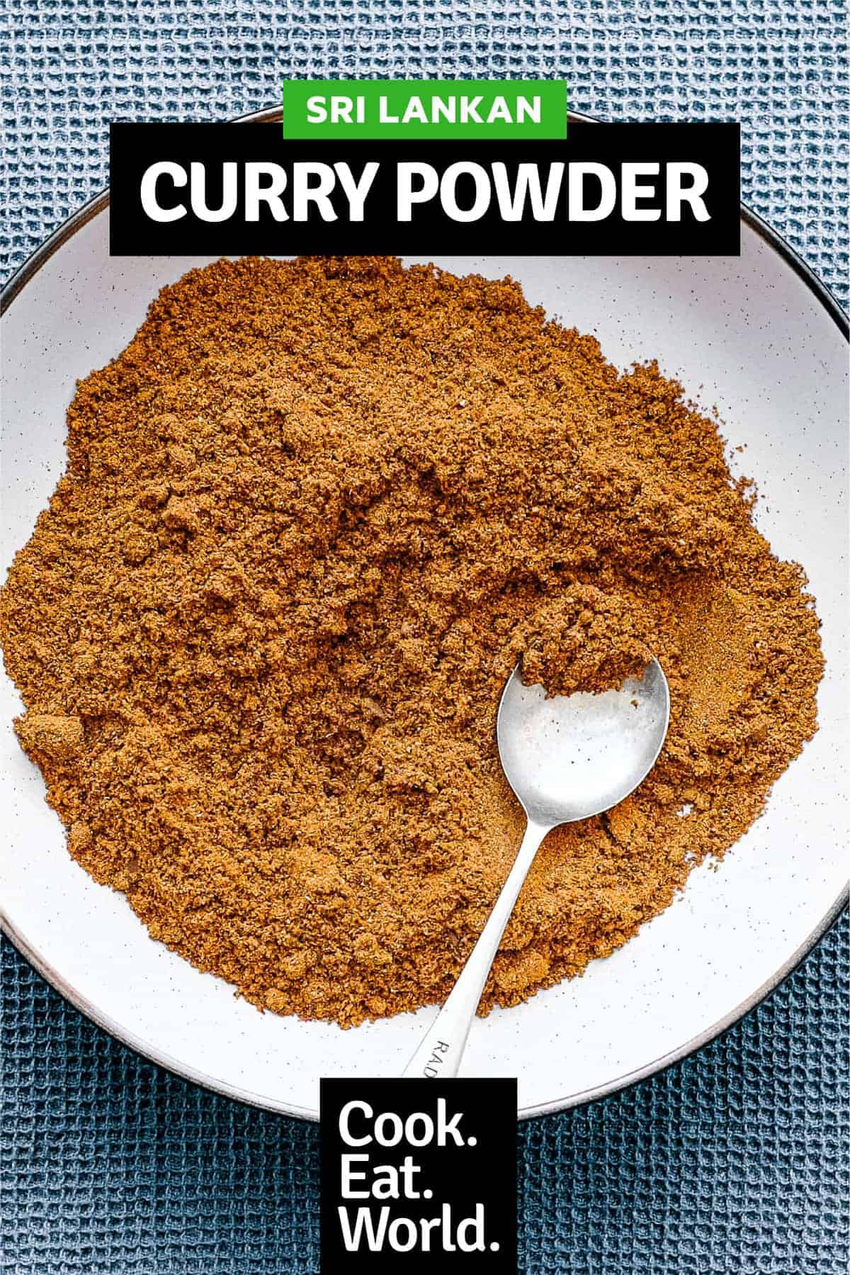 A small bowl of Sri Lankan curry powder with a spoon