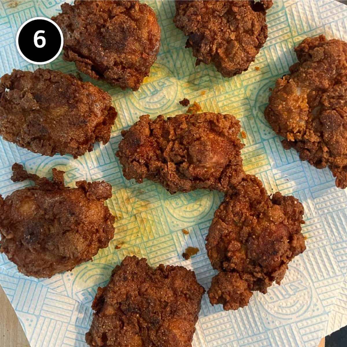 Malaysian fried chicken draining on paper towels.