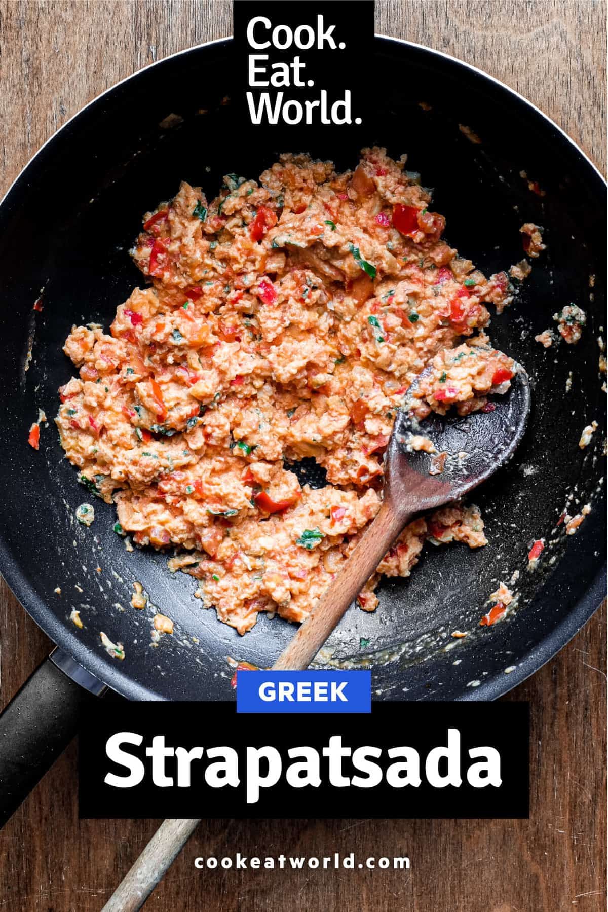 A pan of Greek strapatsada and a wooden spoon.