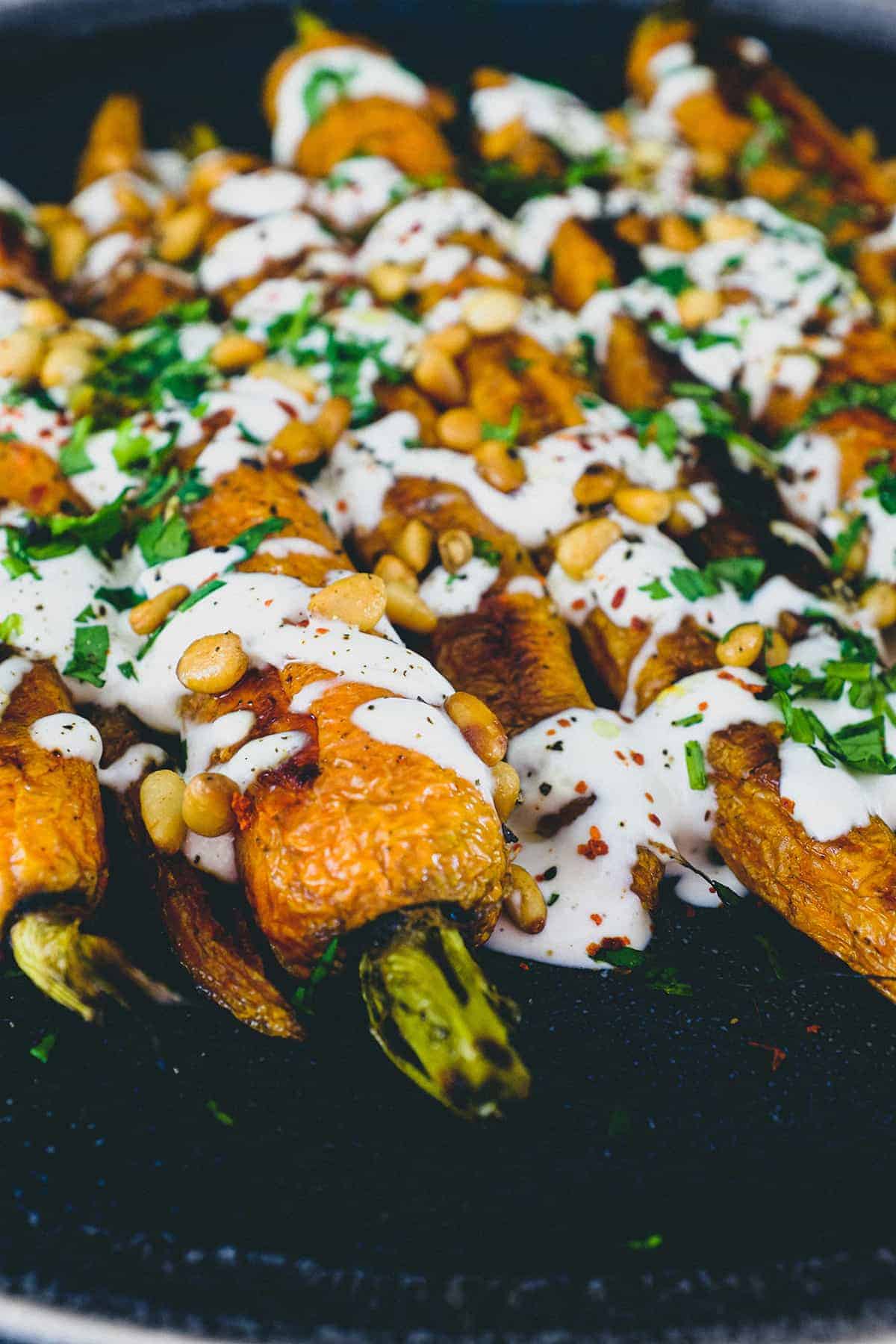 Roasted carrots topped with a tahini & yoghurt sauce, toasted pine nuts and fresh herbs