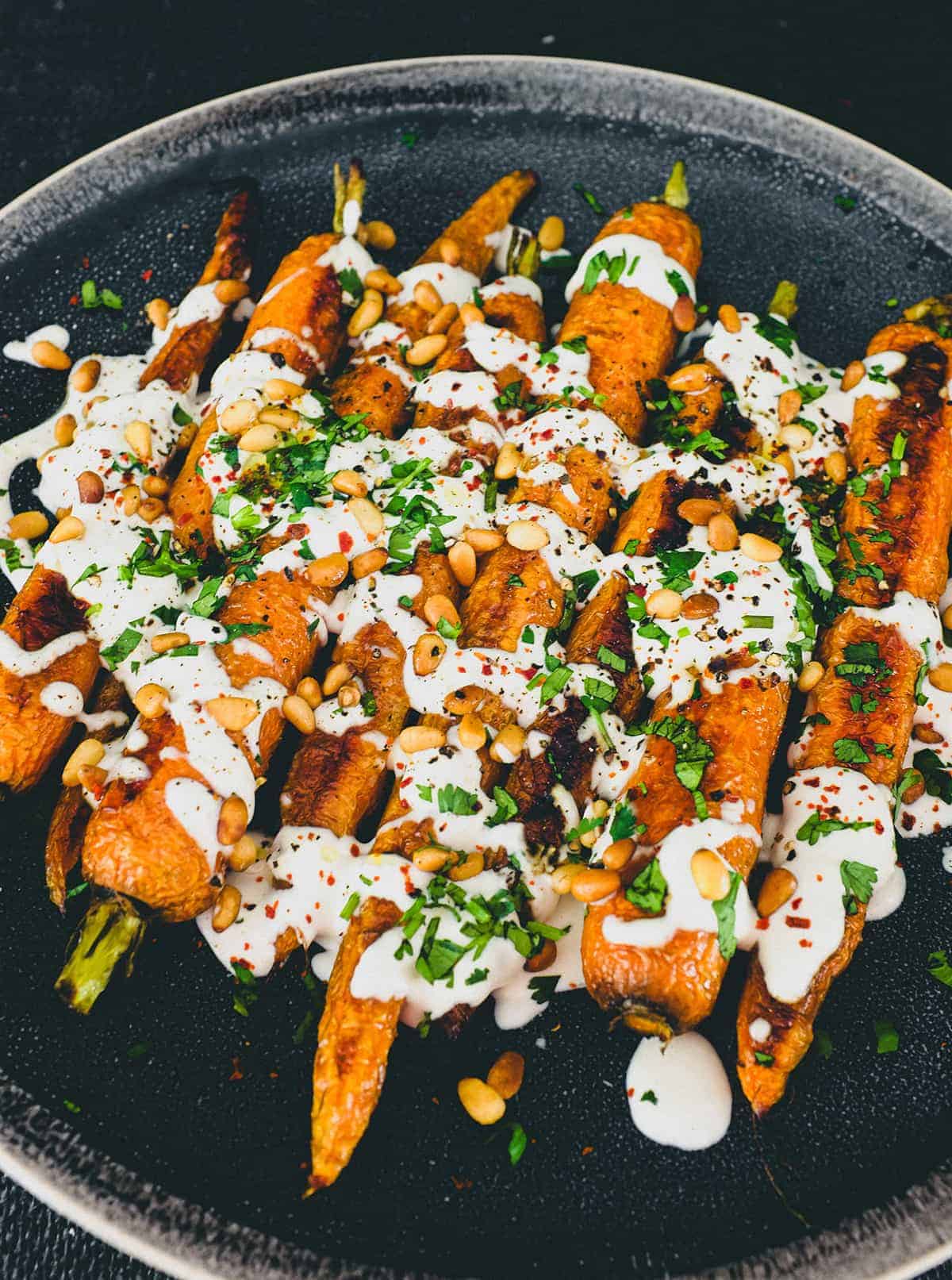 Roasted carrots topped with a tahini & yoghurt sauce, toasted pine nuts and fresh herbs