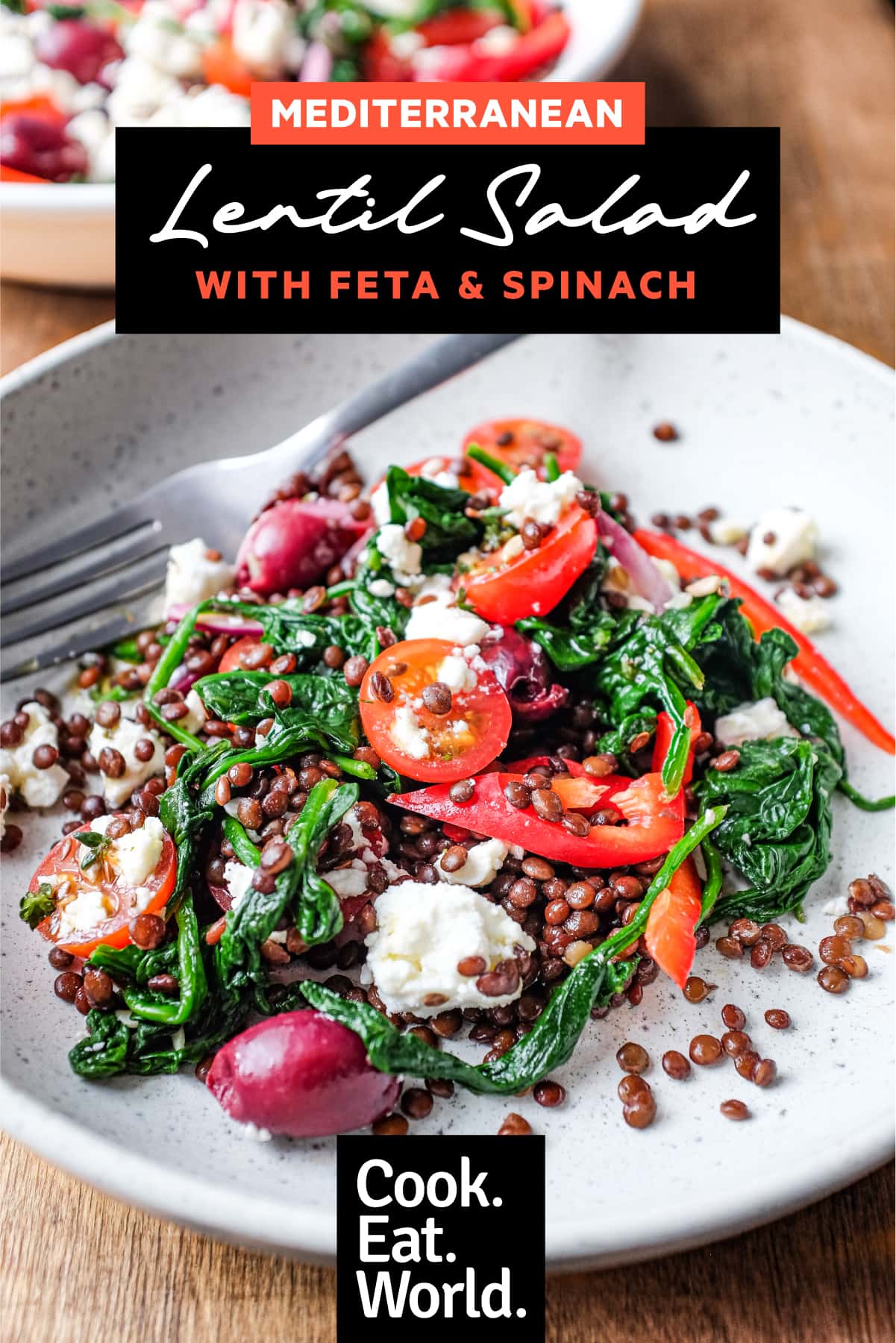 close up of lentil salad with feta crumbled over tomatoes and spinach
