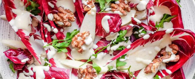 A platter of radicchio salad with pears, walnuts, parsley and a gorgonzola dressing