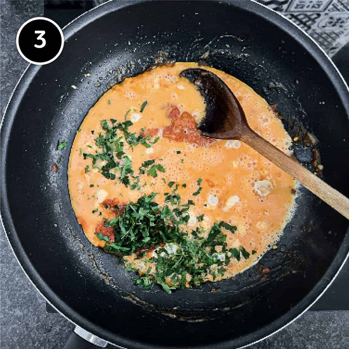 egg and parsley being added to the pan with onion and tomatoes for Greek Strapatsada.