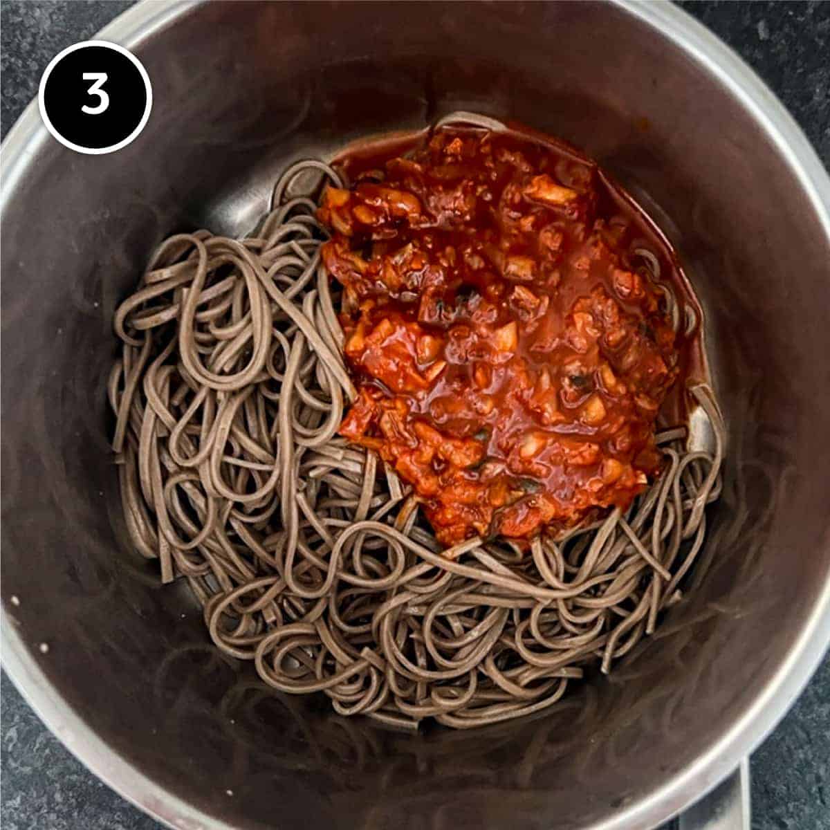 The Bibim Guksu sauce is added to the cooked soba noodles.