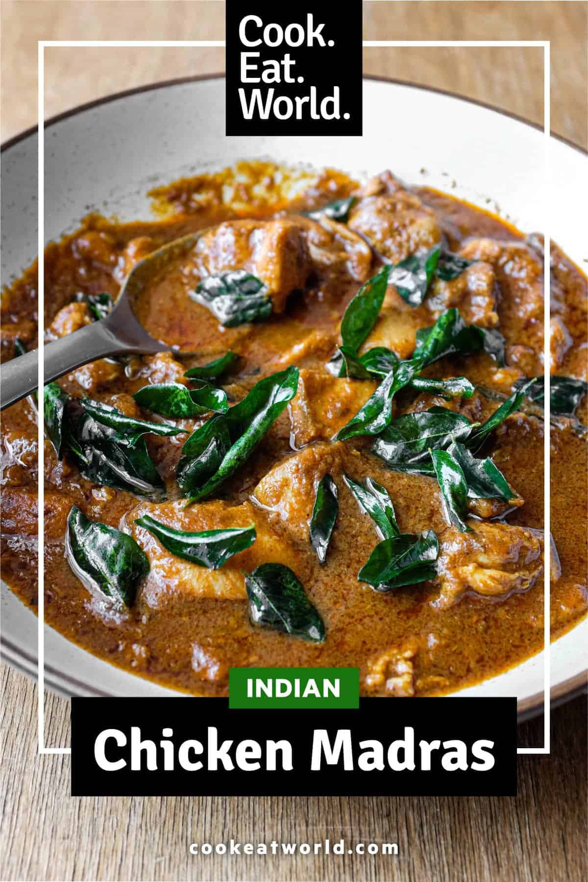 A bowl of Chicken Madras Curry scattered with fried curry leaves