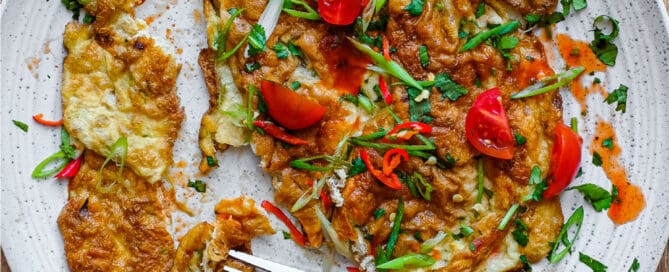 A plate of Thai Omelette with a fork.