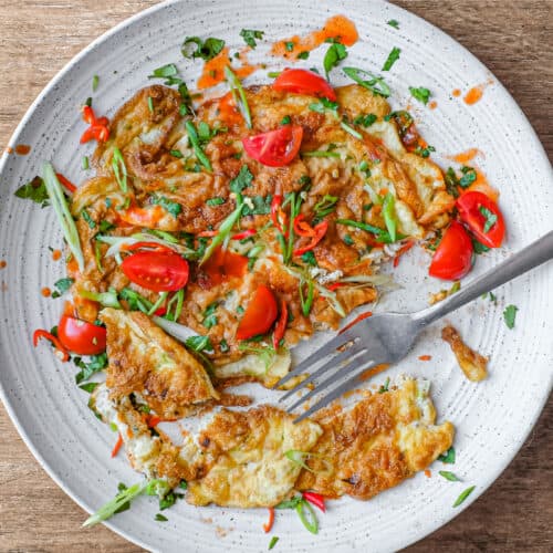 A plate of Thai Omelette with a fork.