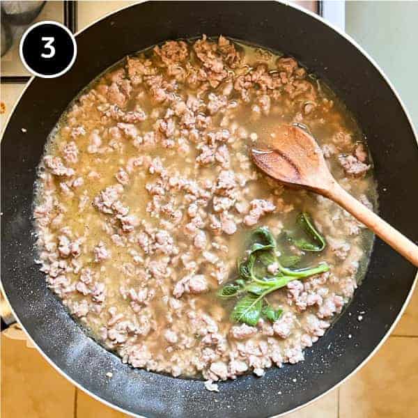 Sausage ragu being simmered in a pan