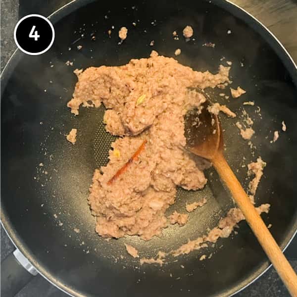 Onion puree frying with spices in a pan