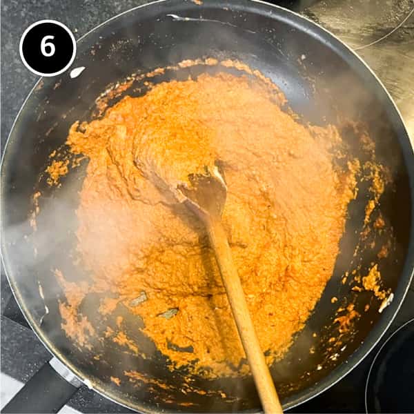 Yoghurt stirred into an onion paste for a curry sauce in a pan