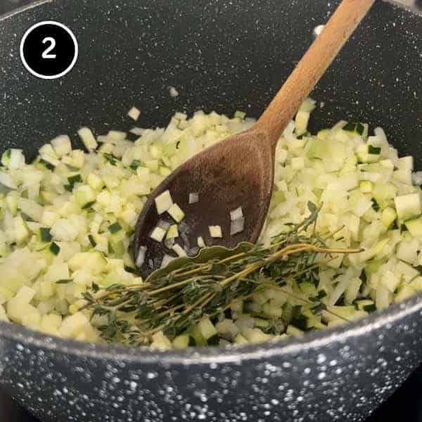 Frying diced onion, celery and zucchini in a pan