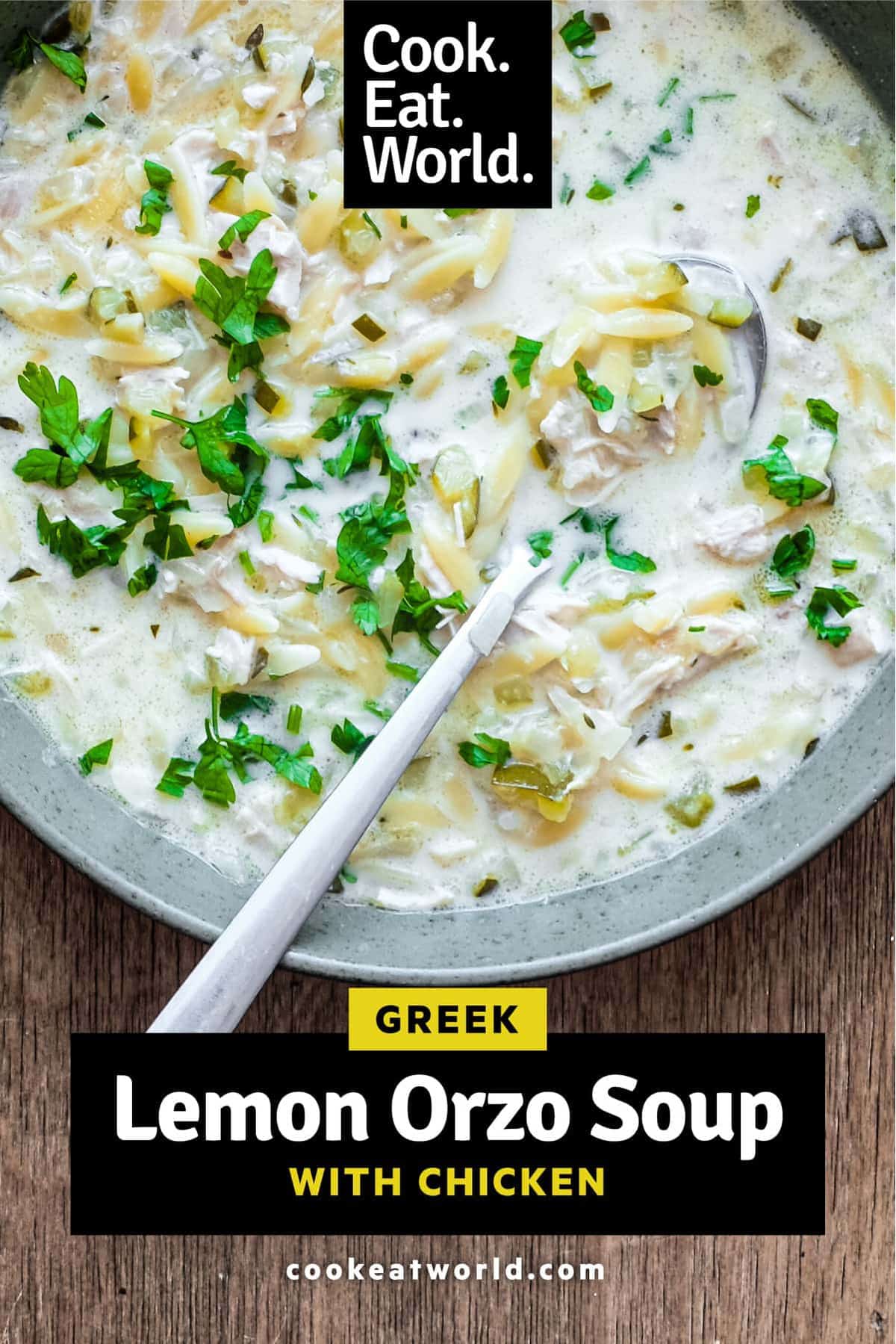 A bowl of Greek lemon orzo soup with chicken with a spoon