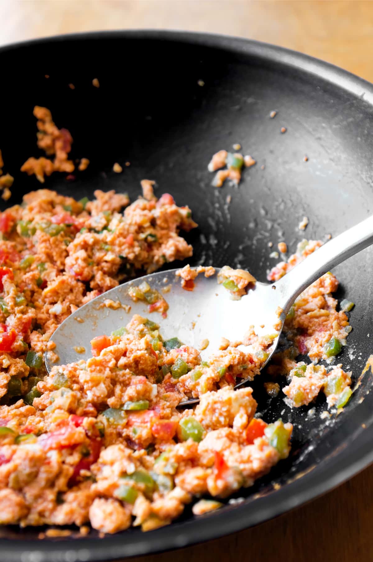 A pan of Turkish menemen with a large serving spoon