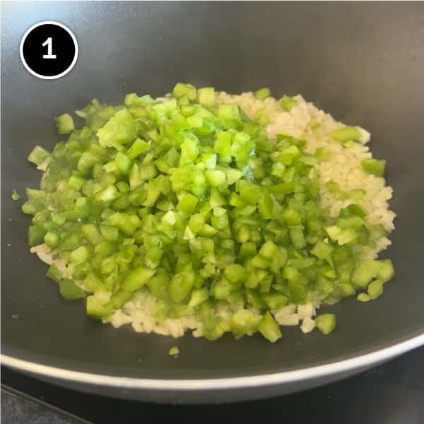 Frying diced shallot and green bell pepper in a large pan