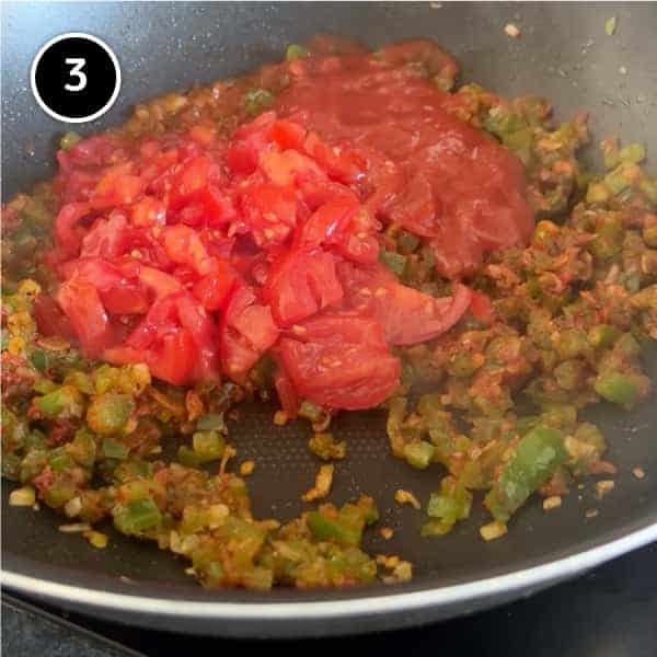 Fresh tomato and passata being added to menemen sauce mix