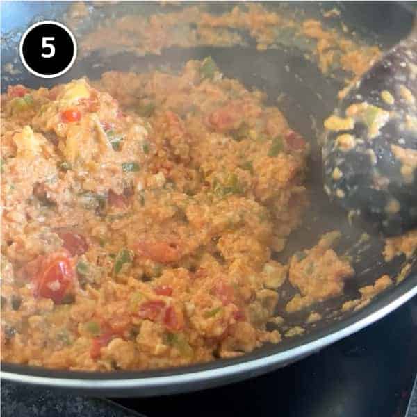 A pan of Turkish menemen being stirred