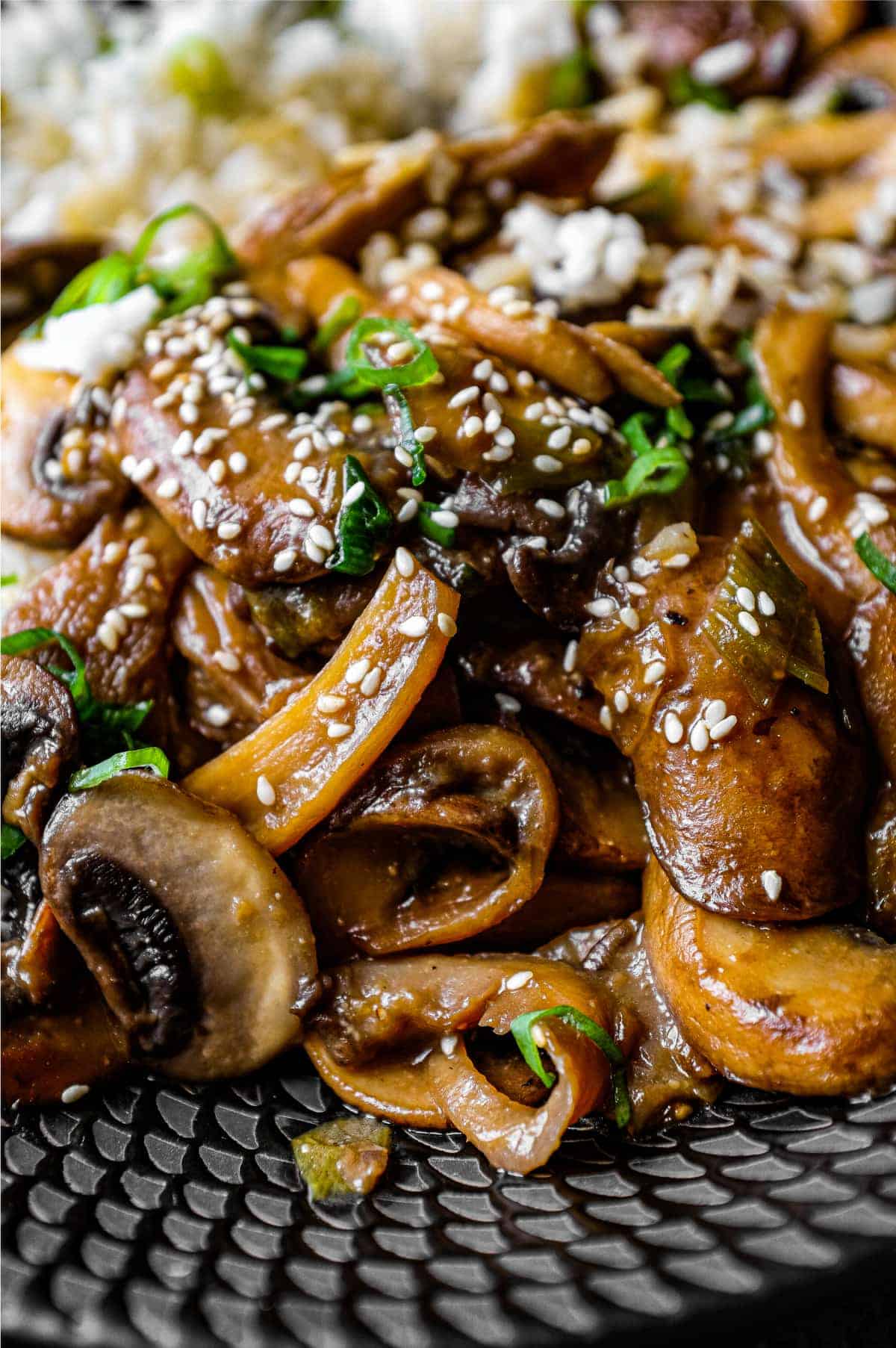 A bowl of rice topped with sautéed miso mushrooms. 