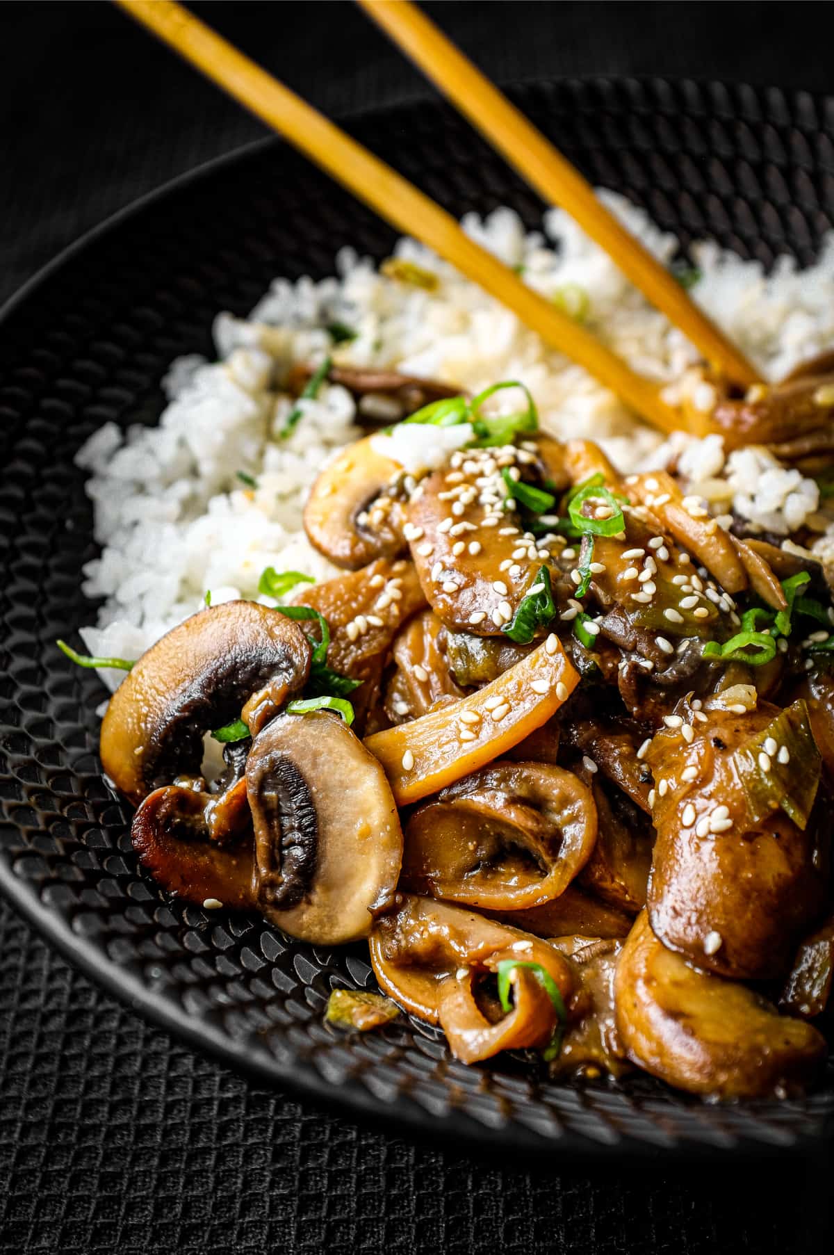 A bowl of rice topped with sautéed miso mushrooms. 