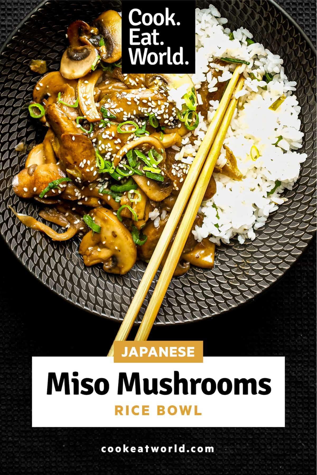 A bowl of rice topped with sautéed miso mushrooms. Chopsticks sit alongside the bowl.