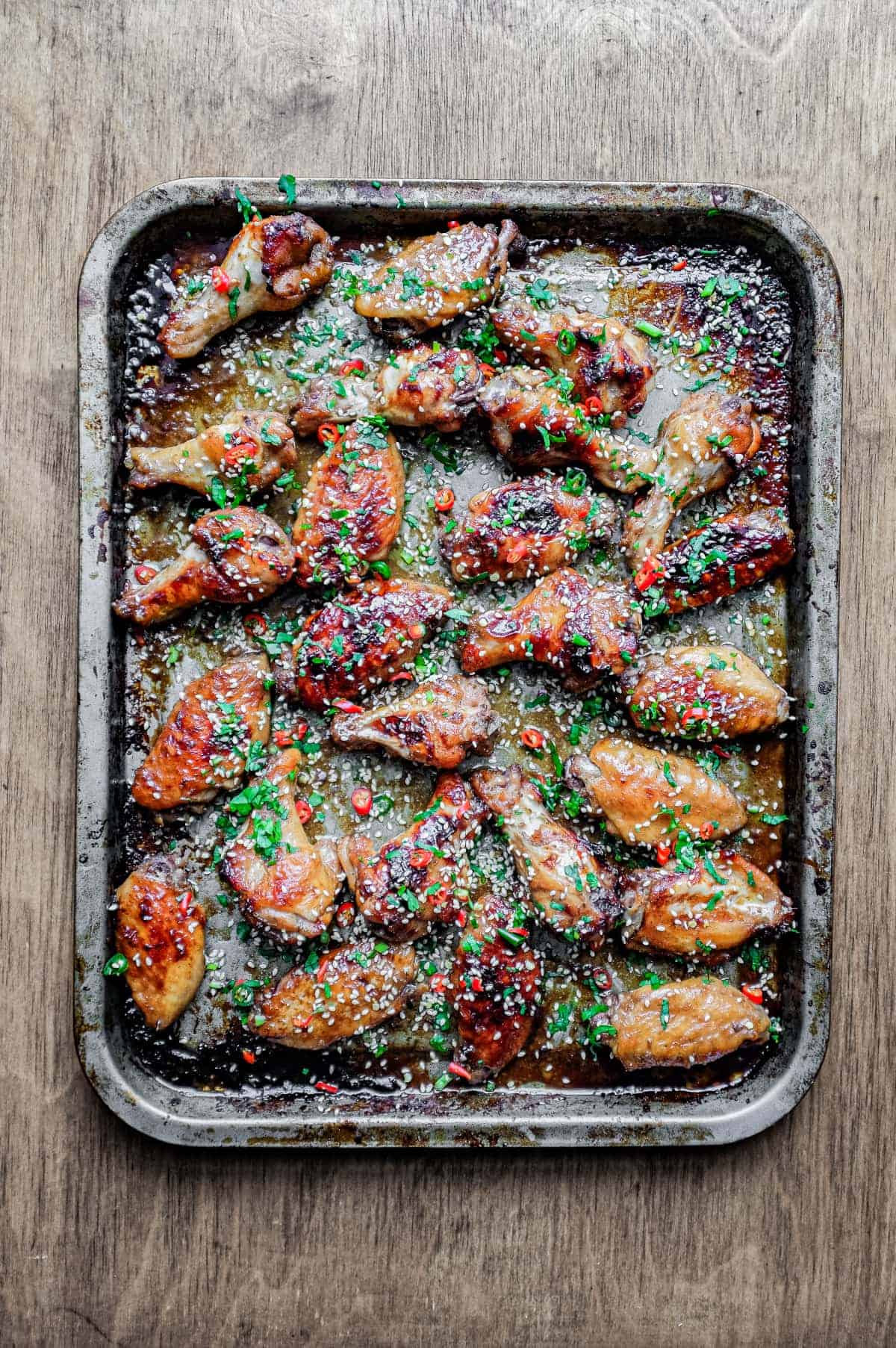 A baking sheet with Sticky Baked Chinese Chicken Wings