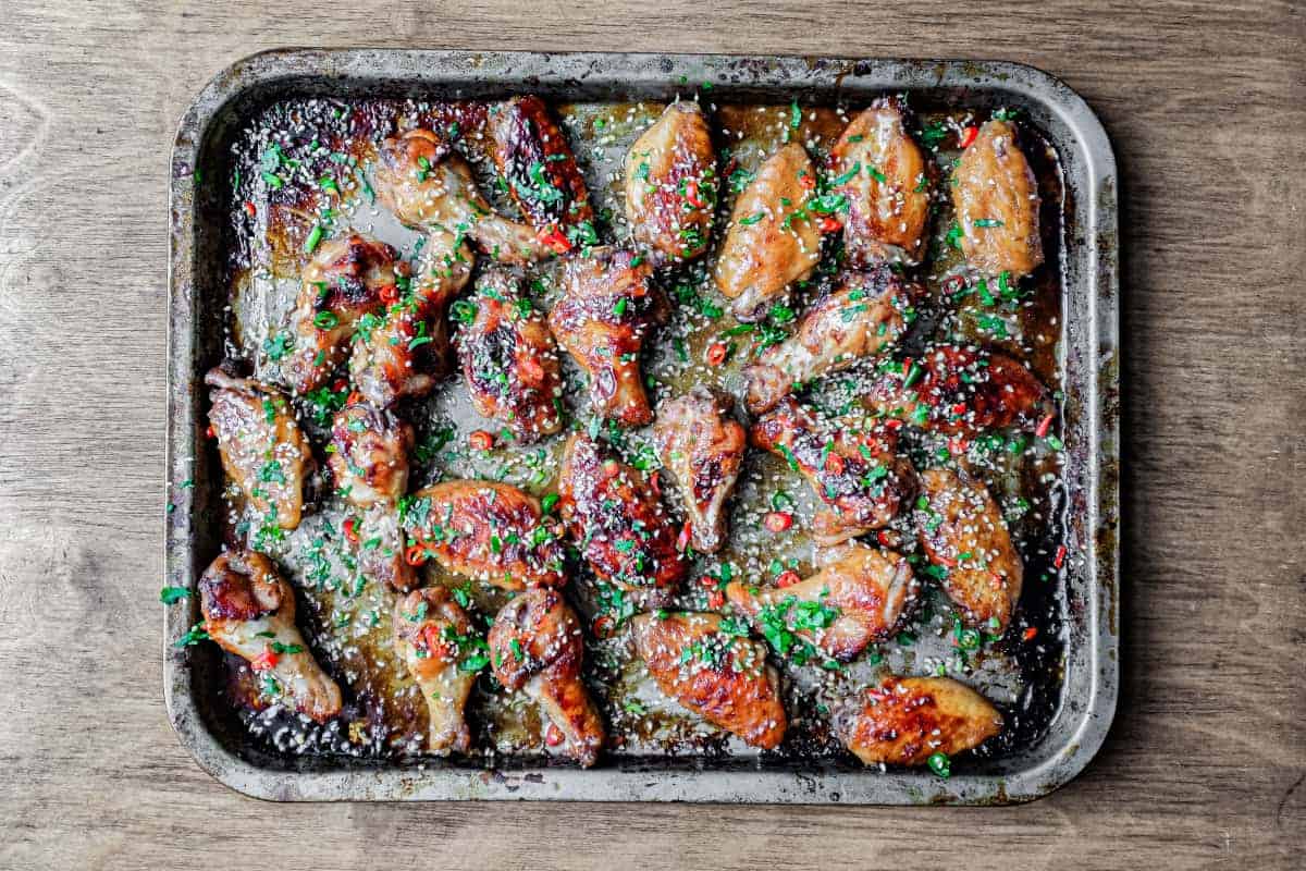 A baking sheet with Sticky Baked Chinese Chicken Wings