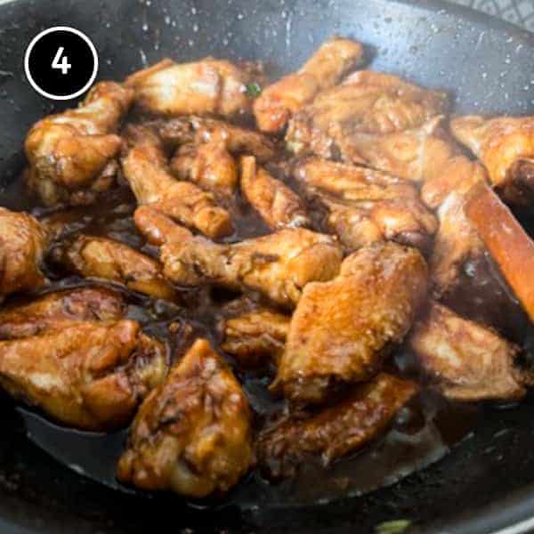 Indonesian chicken wings cooking in a pan