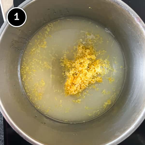 Sugar, lemon zest and lemon juice are in a pan, being heated.