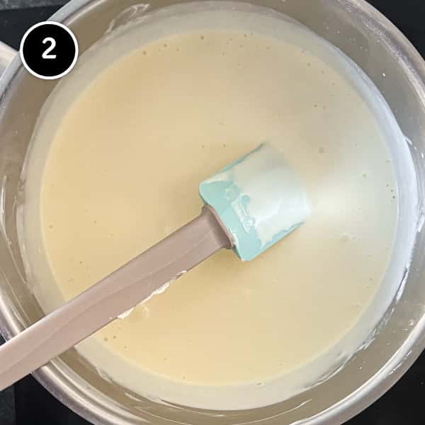 Combining the mascarpone and cream and heating. in a pan until how using a spatula.
