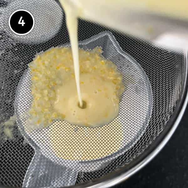Straining the lemon cream through a sieve.