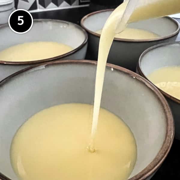 Pouring the strained lemon cream into bowls, to be refrigerated.