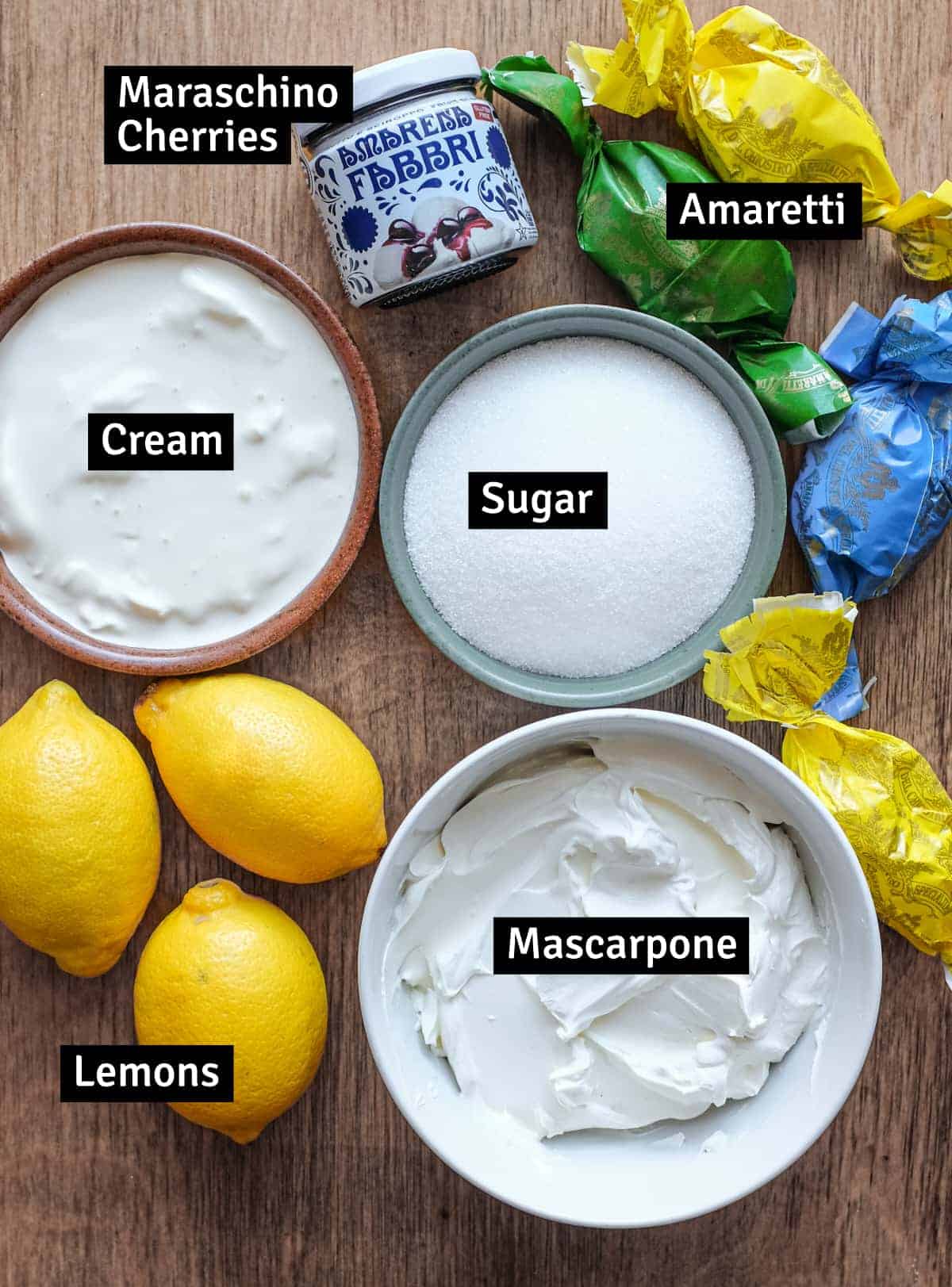 The ingredients for Italian Lemon Cream: Mascarpone, cream, sugar, lemon, maraschino cherries and amaretti biscuits.