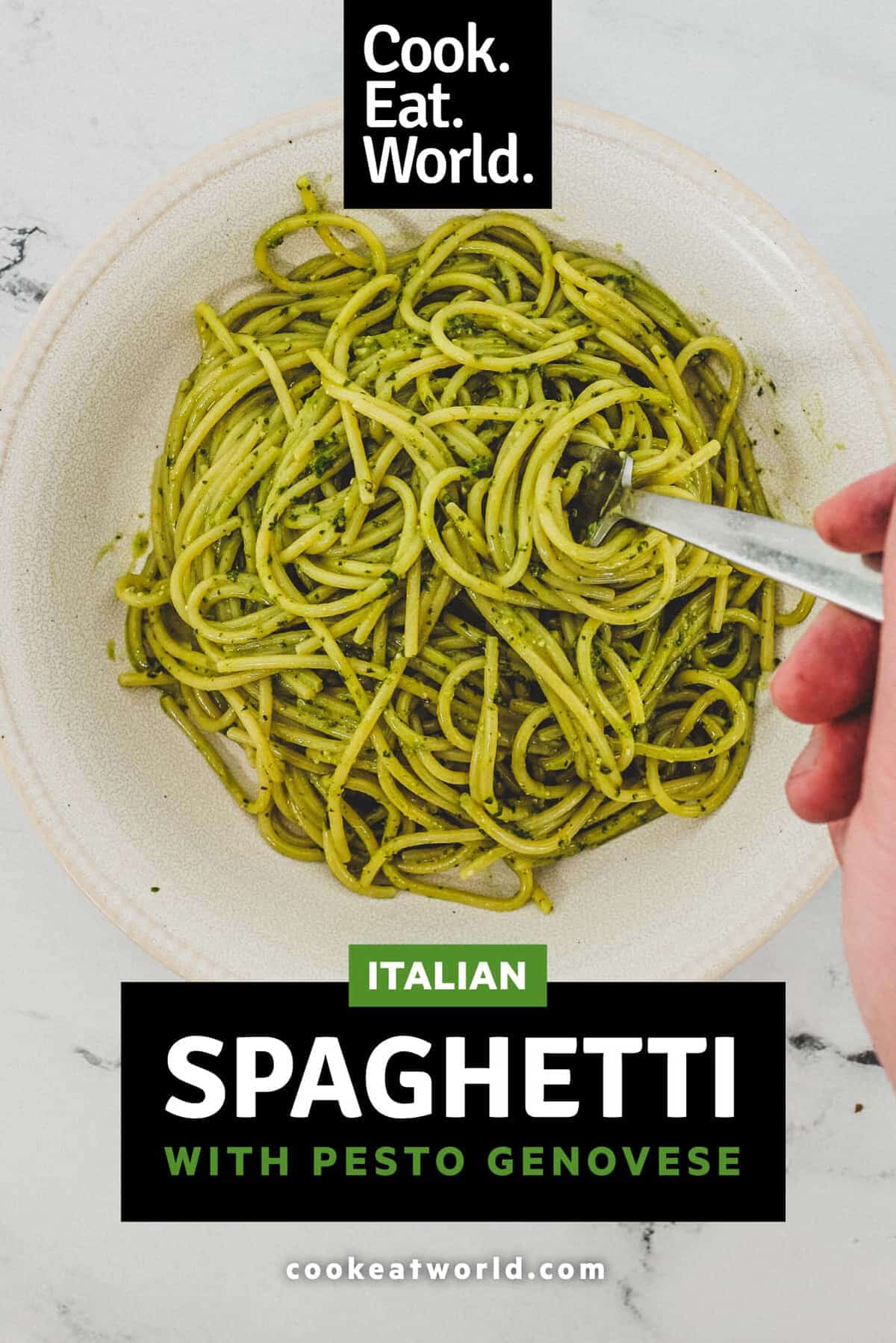 A bowl of Spaghetti with Pesto Genovese. A fork twists around a few noodles.