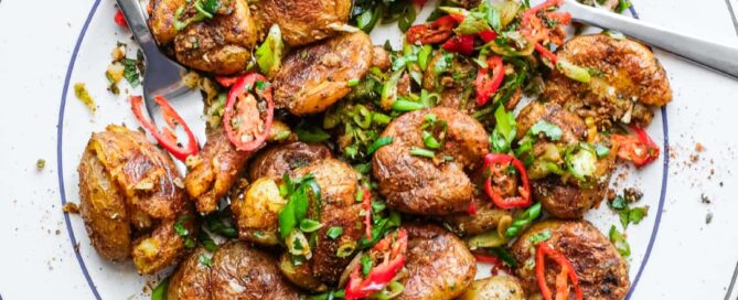 A platter of Indian Gunpowder potatoes tossed in a spice mix and fresh spring onion, chillies and cilantro