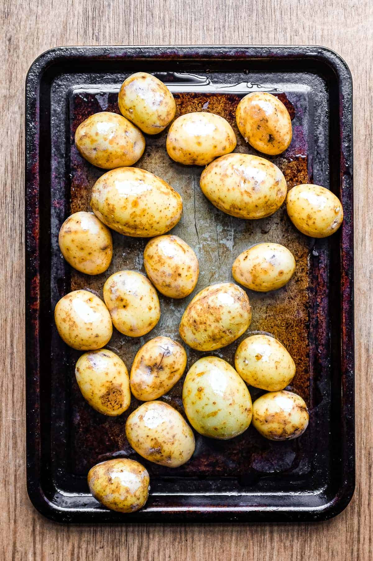A baking sheet with baby potatoes