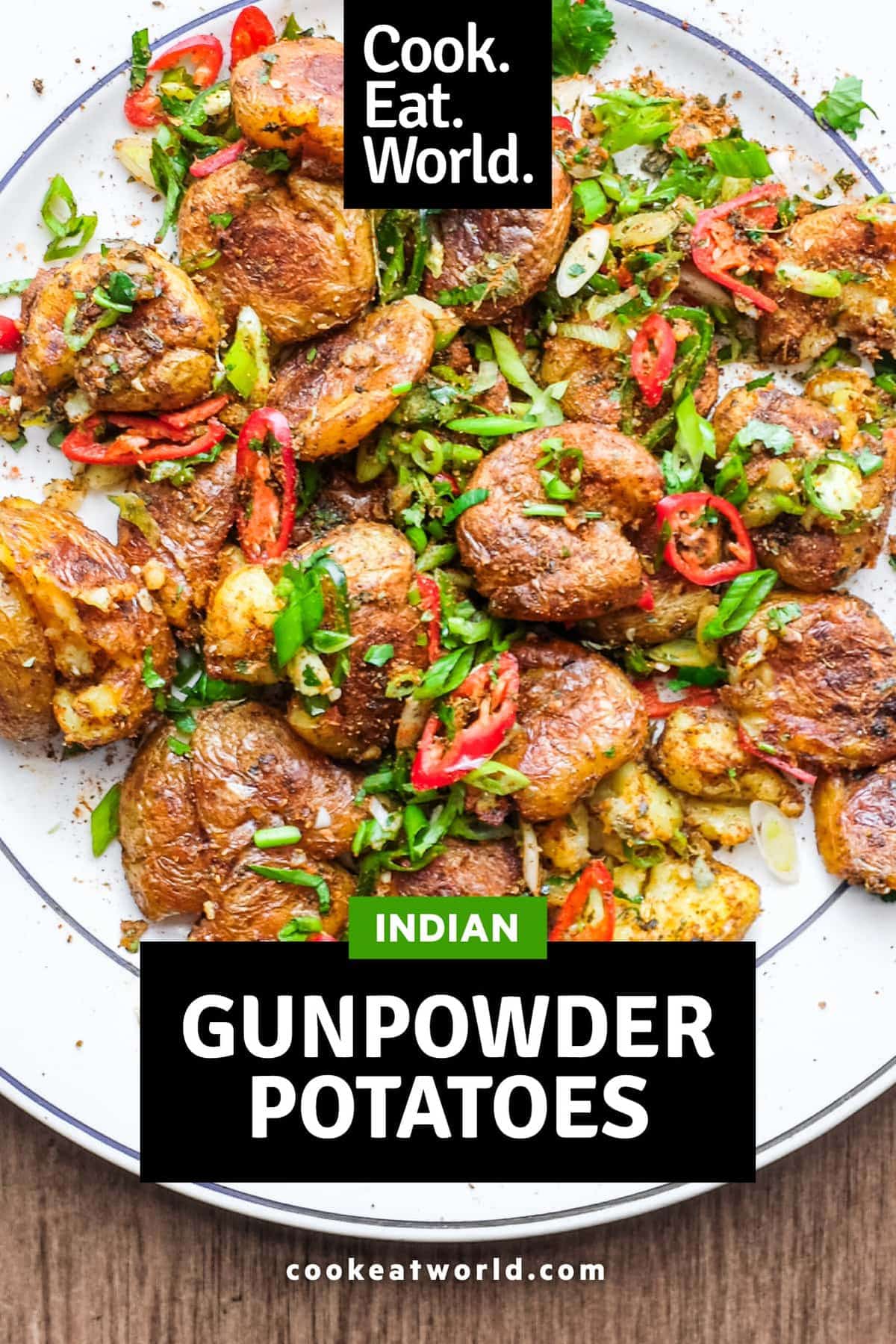 A platter of Indian Gunpowder potatoes tossed in a spice mix and fresh spring onion, chillies and cilantro