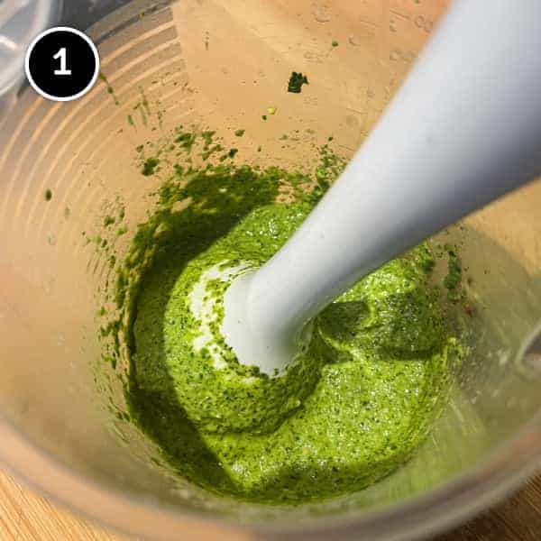A stick blender, combining cilantro and chillies into a chutney.