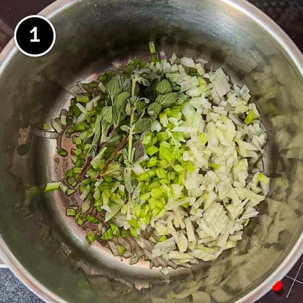 Italian Sausage and Lentils | cookeatworld.com Onions, celery and fresh oregano being sautéed in a small pan