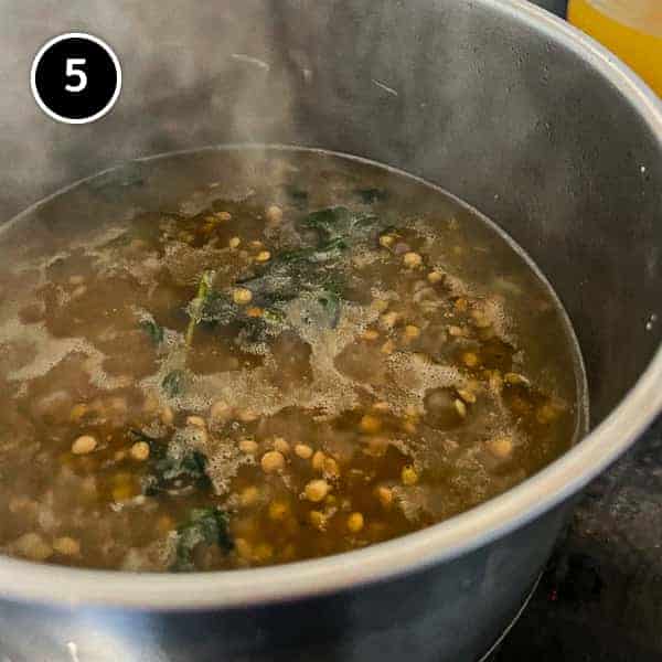 Italian Sausage and Lentils | cookeatworld.com Lentils simmering in a small pan