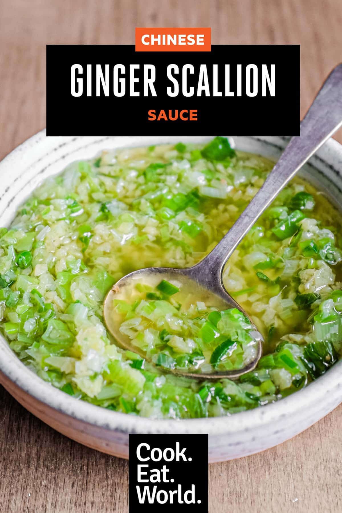 A small bowl of Chinese Ginger Scallion Sauce with a small serving spoon