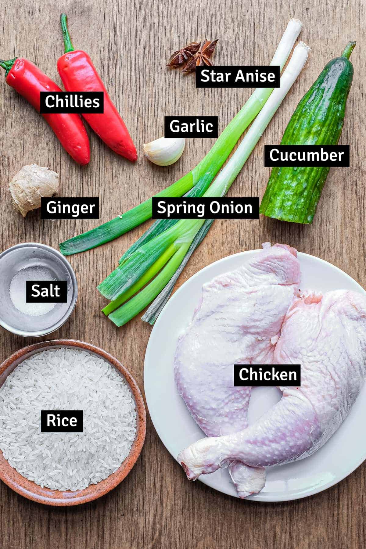 The ingredients for Hainan Chicken and Rice: Chicken portions, spring onion, ginger, garlic, rice, star anise, chillies, cucumber and salt