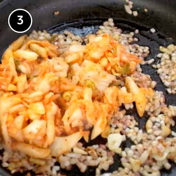 Kimchi Fried Rice | cookeatworld.com Kimchi and onions frying in a pan