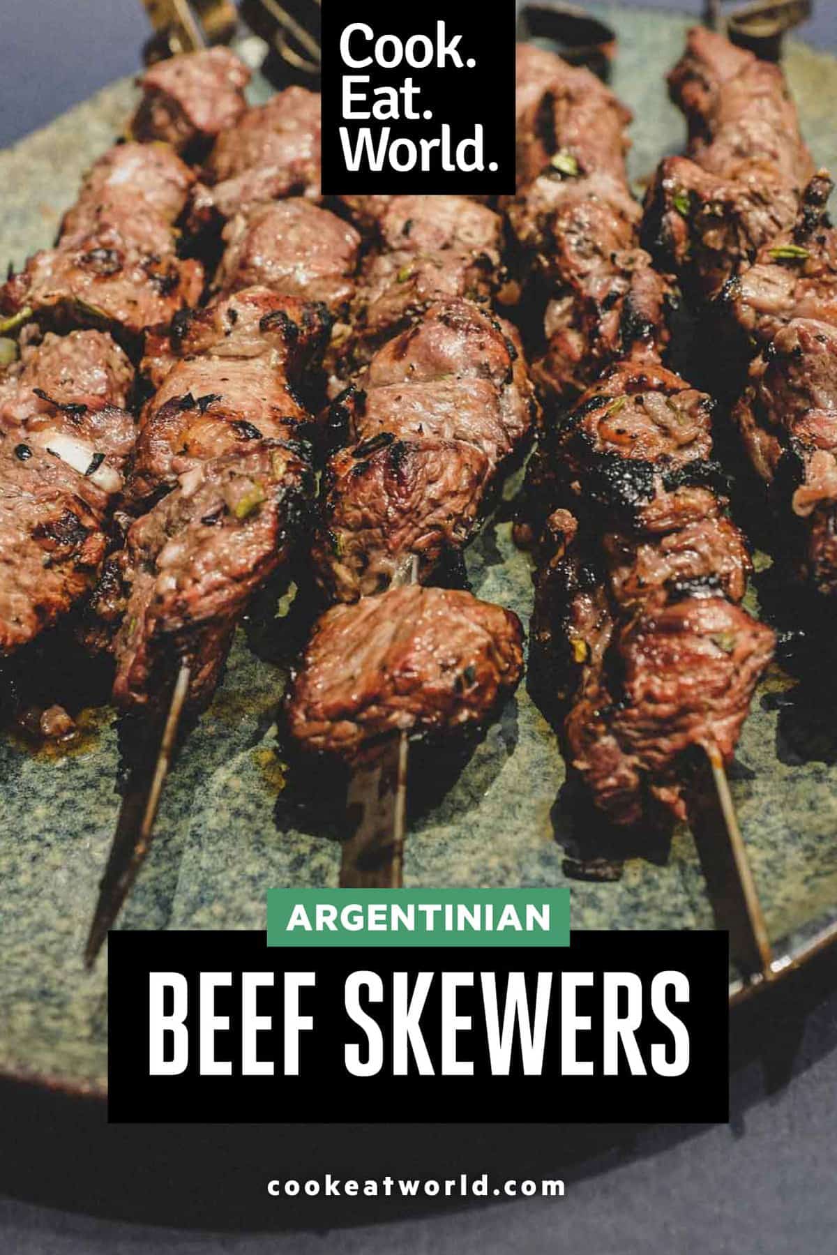 Argentinian beef skewers on metal skewers on a platter