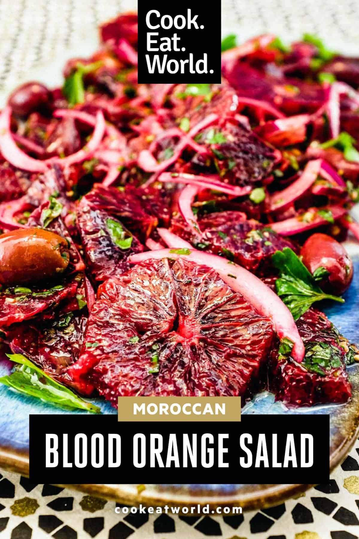 A platter of blood orange salad with black olives, onion and herbs