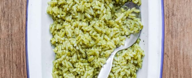 A bowl of Mexican Cilantro Rice (Green Rice) with a spoon.