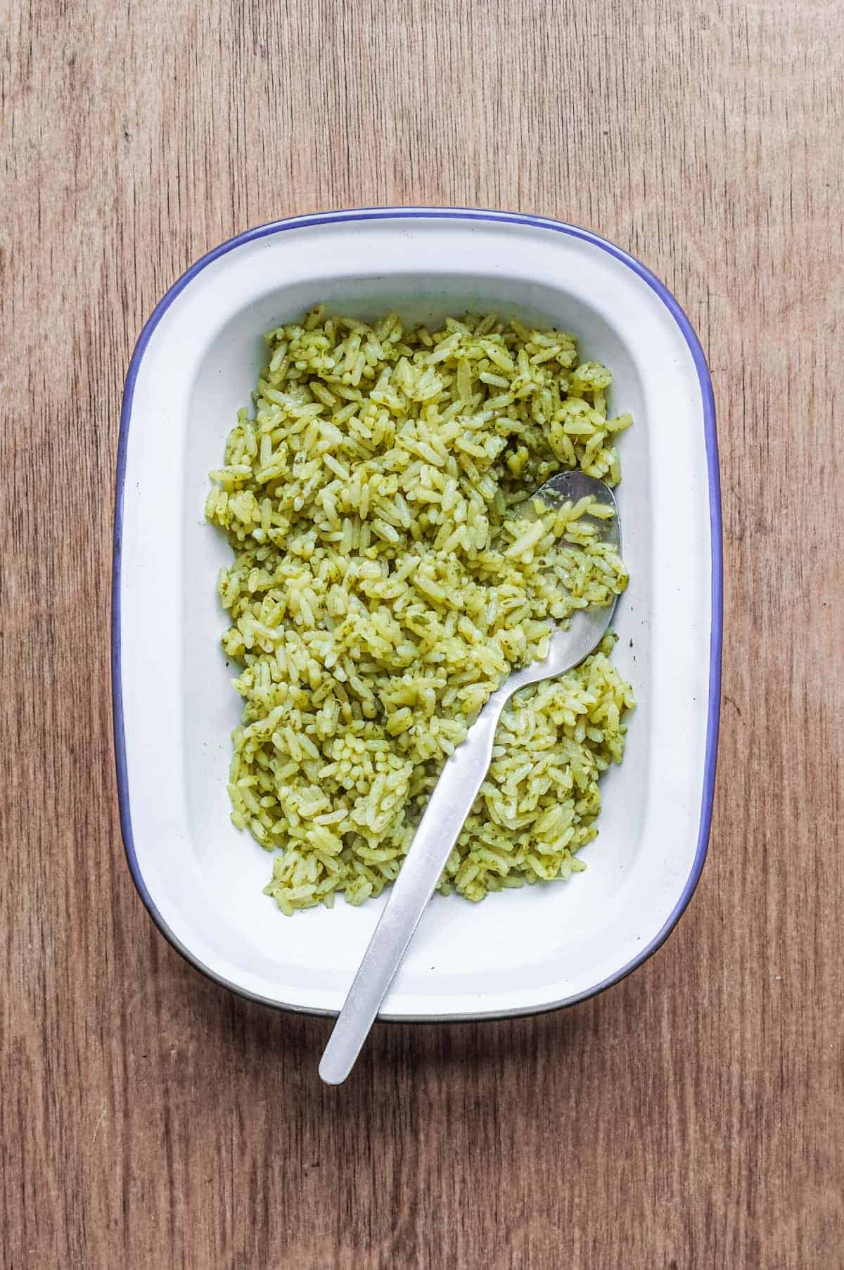 A bowl of Mexican Cilantro Rice (Green Rice) with a spoon.