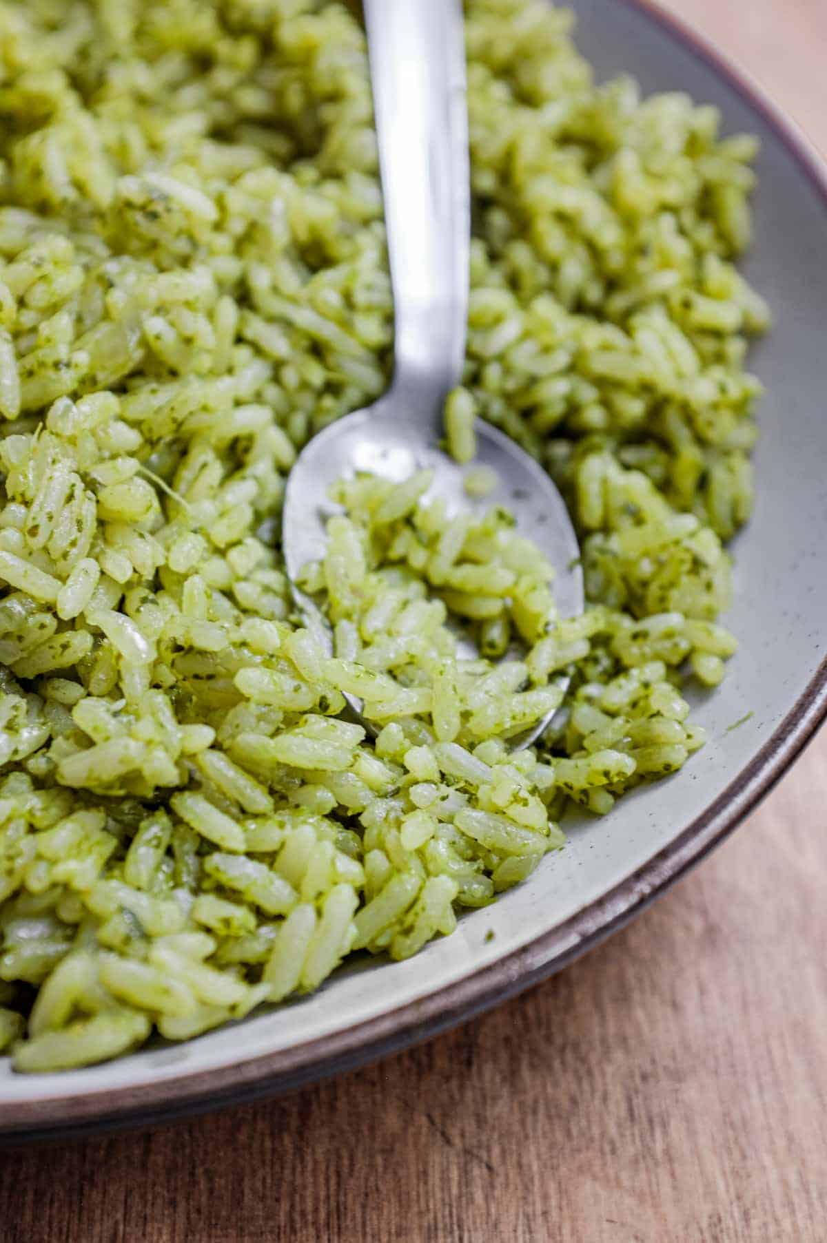 A bowl of Mexican Cilantro Rice (Green Rice) with a spoon.