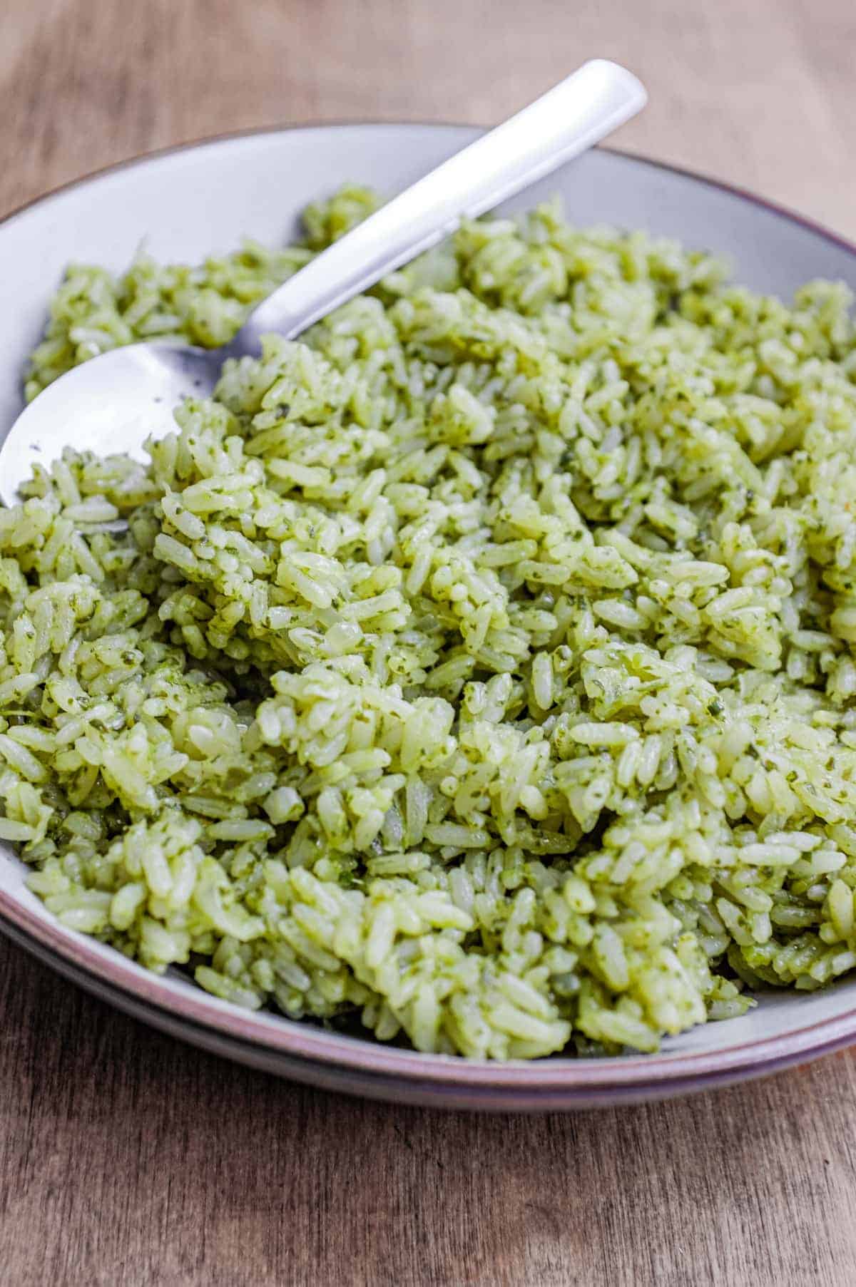 A bowl of Mexican Cilantro Rice (Green Rice) with a spoon.